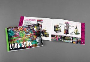 Multiple copies of the 2017 Global Shop Look Book spread out on a table